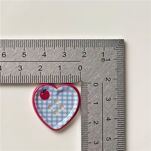 grid patterned red blue heart-shaped apple round button